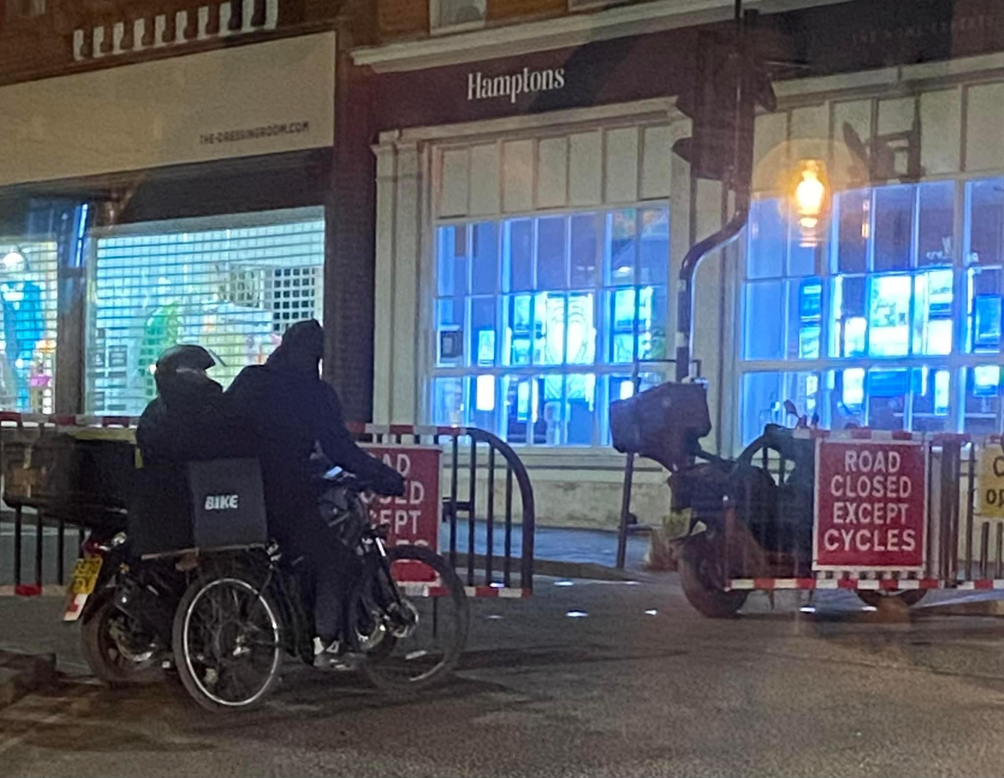 Courier riders cut through the barriers closing High Street. St Albans.