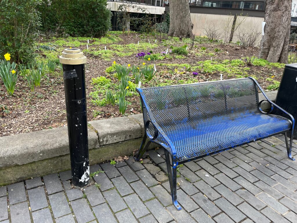 Chipped paint on a bench and bollard.