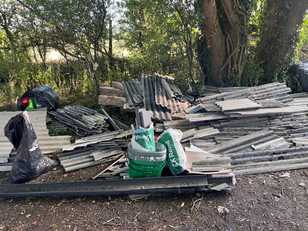 Builder's waste dumped by the side of the road.