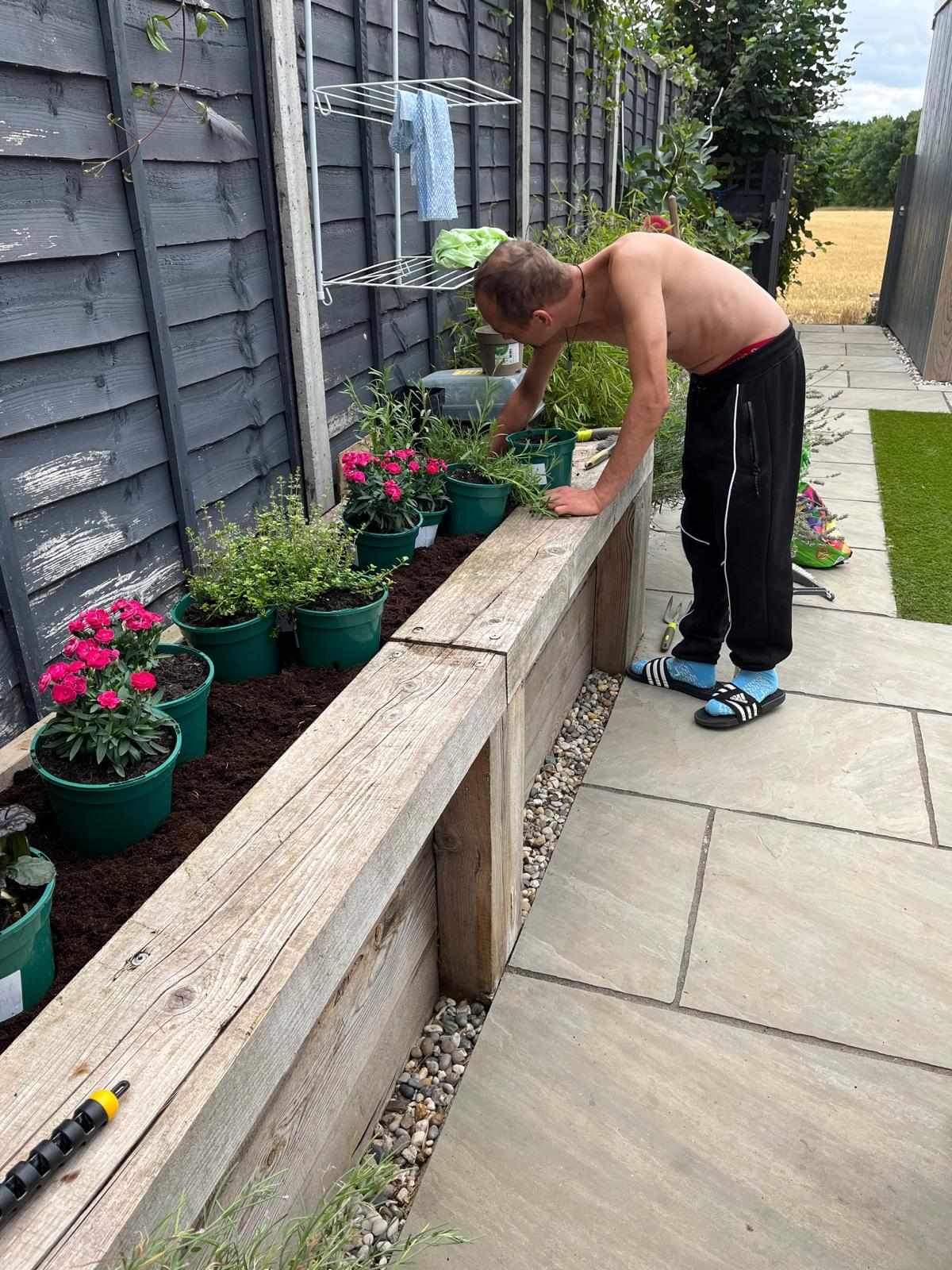 A resident working in the garden at Hope House.