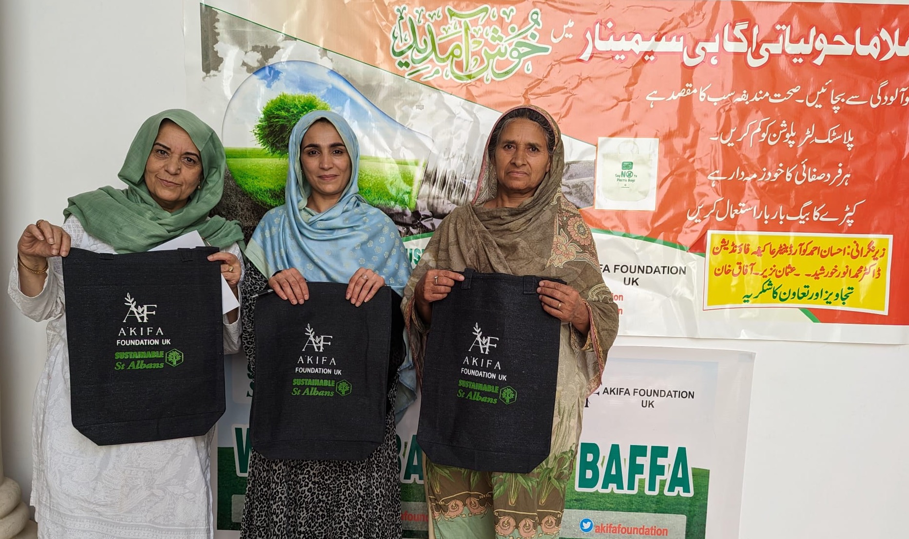 Farhat Zia (far left) with local health professionals in Baffa holding the reusable bags.