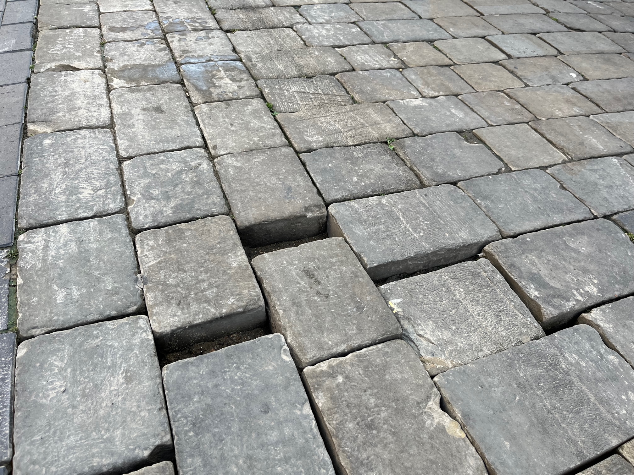 The poor state of the surface in Market Place.