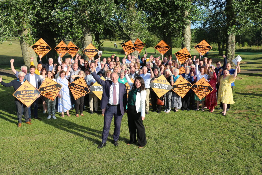 Liberal Democrat leader Ed Davey with Victoria Collins and local supporters.
