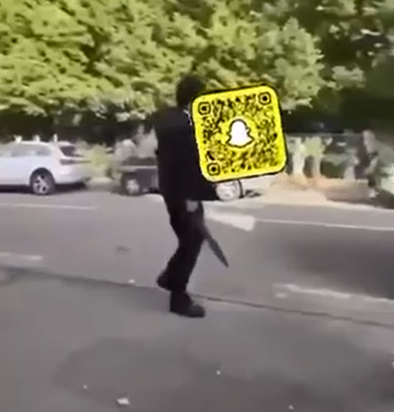 This screenshot from a video taken before the stabbing shows a teenager with a machete.