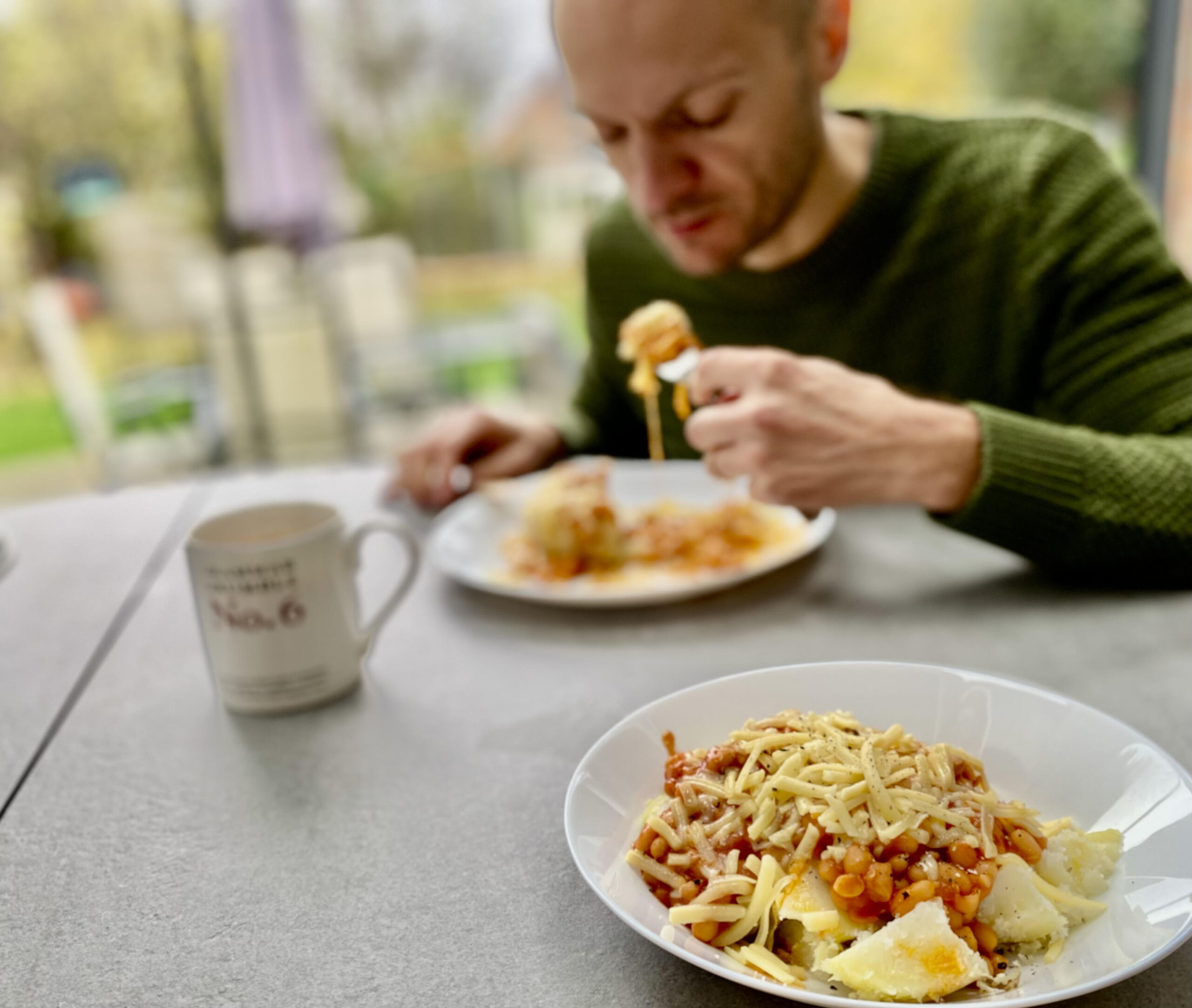Elena's husband tucks in to his potato.