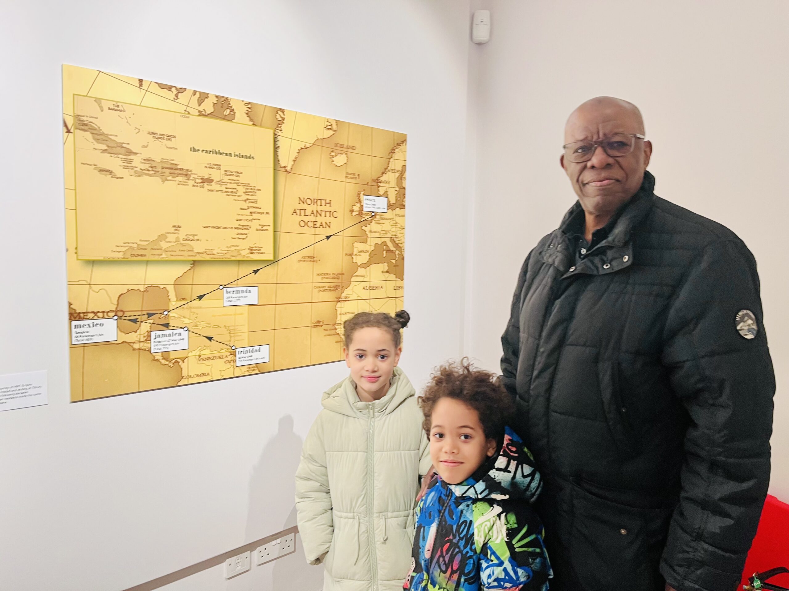 Naran McCallum and his grandchildren at the Becoming Us exhibition.