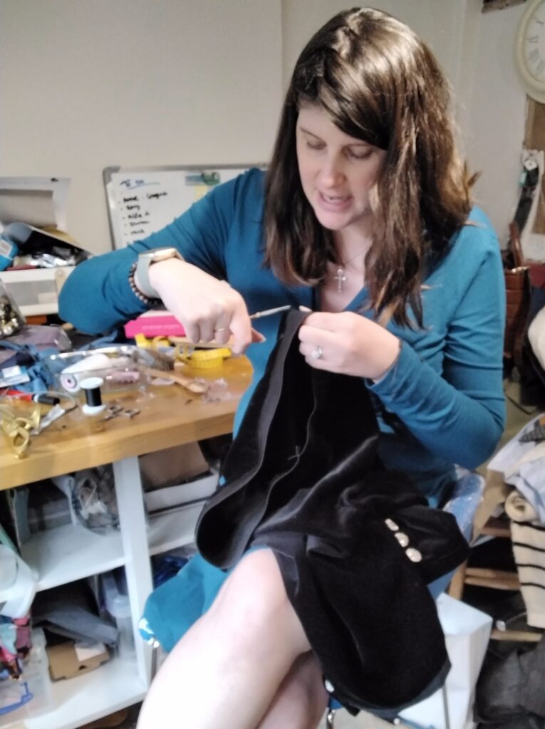 Jorden sewing the breeches.