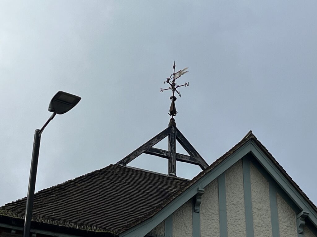A weather vane above The Peahen.