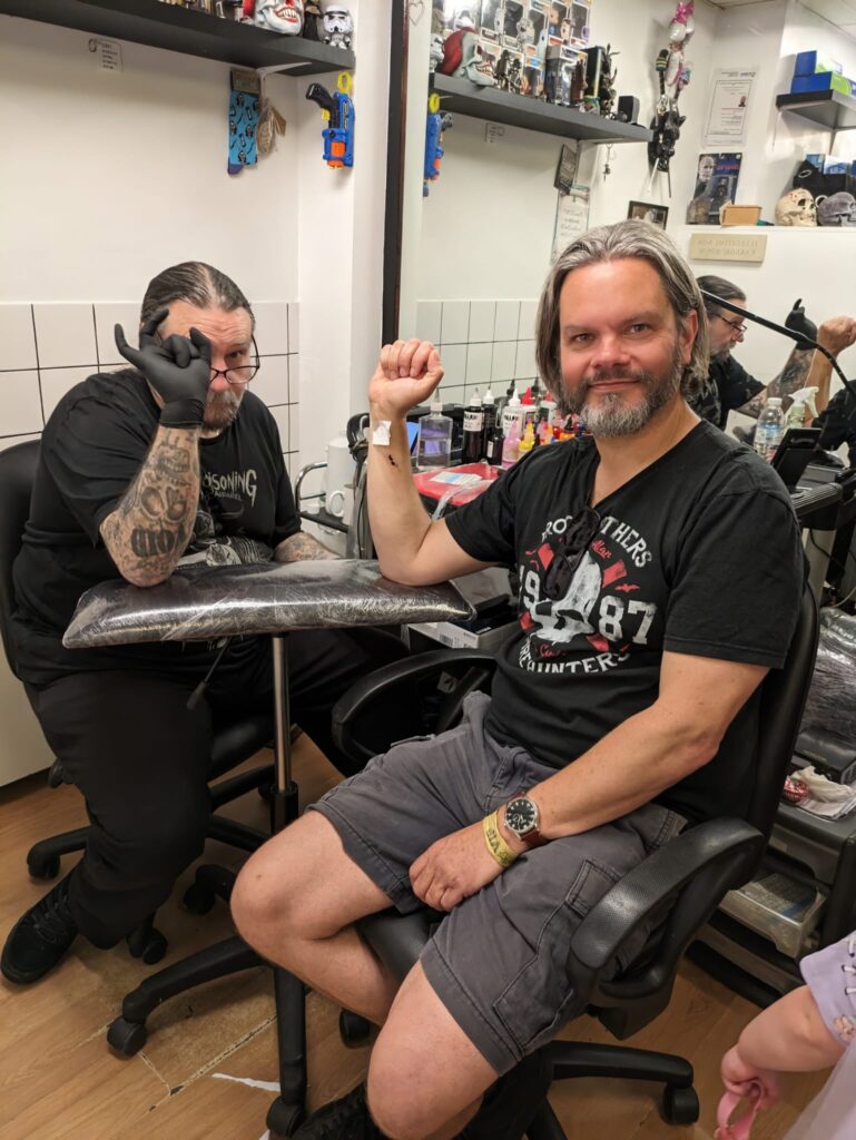 Matt Adams, editor of the St Albans Times, receives his tattoo.