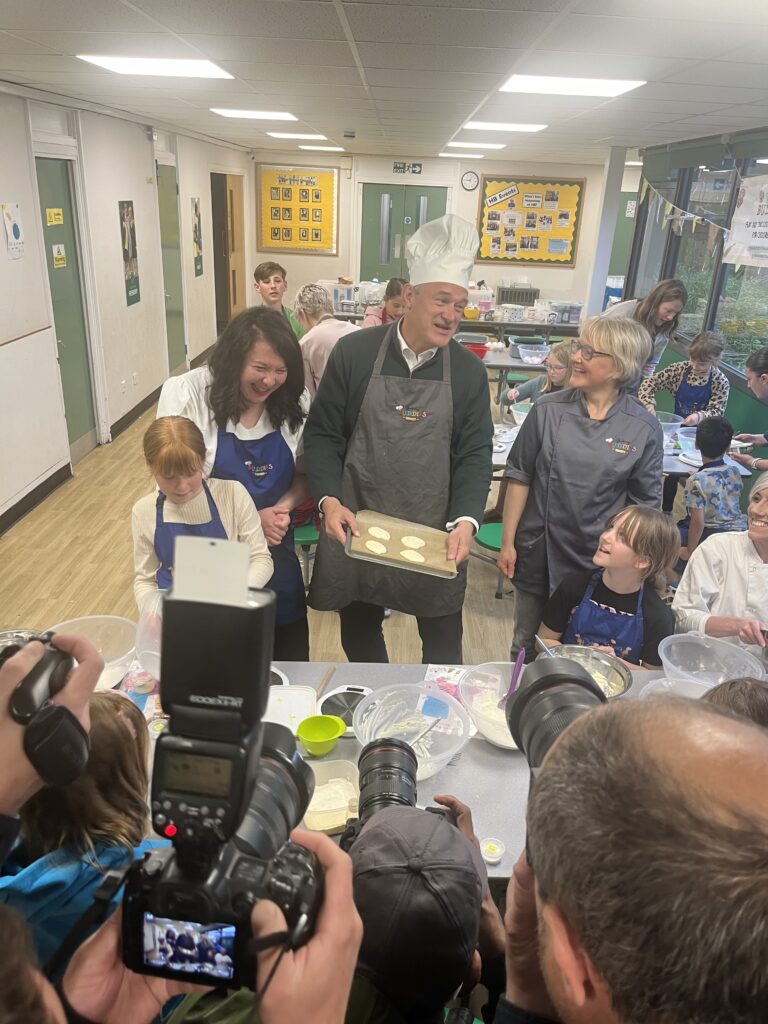 Victoria Collins and Ed Davey with their biscuits.