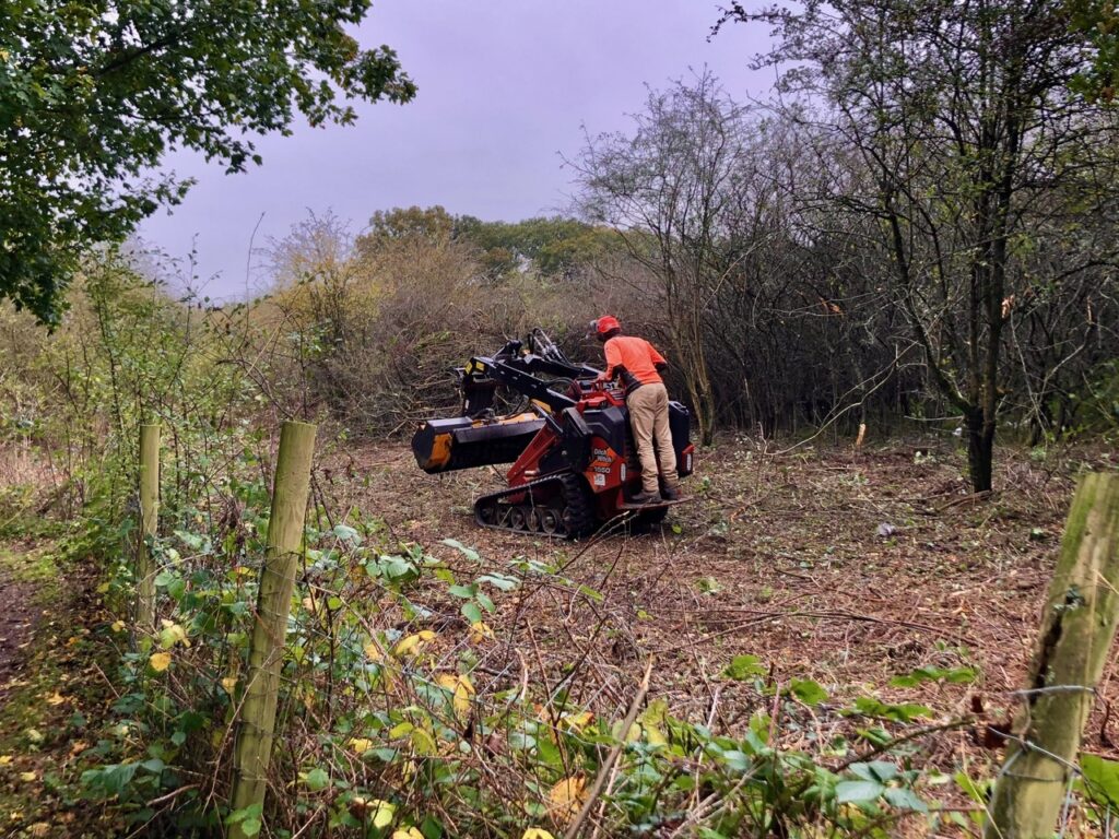 Contractors at work clearing scrubland at Bedmond Lane Wildlife Meadow.