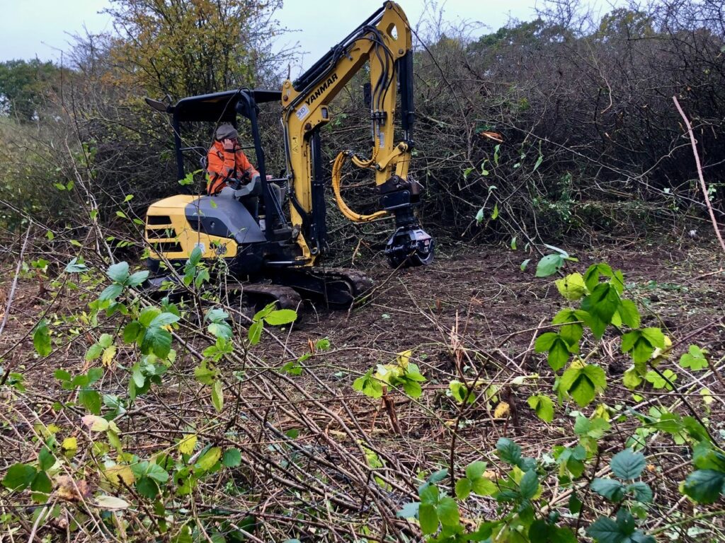 Contractors at work clearing scrubland at Bedmond Lane Wildlife Meadow.