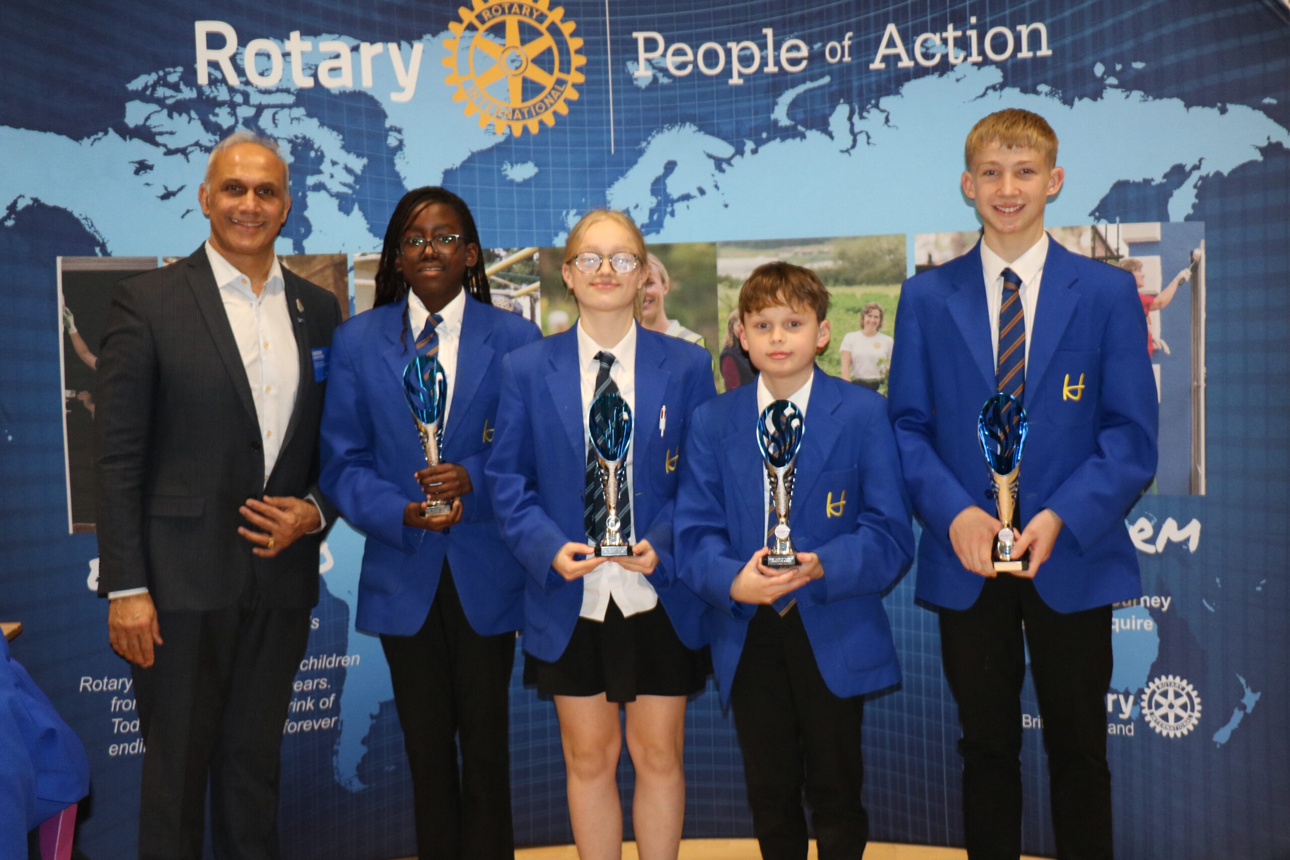 Chairman of Rotary in Great Britain and Ireland, Nitesh Joshi, with Heathlands School Foundation Competition Team of Maisie Sly, Yulia Lazarenko, Arielle Mpanumpanu and Dawood Alamy.