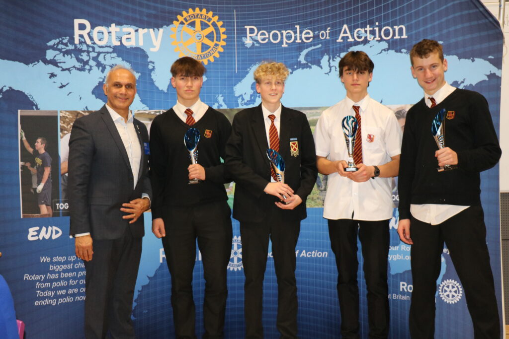 Chairman of Rotary in Great Britain and Ireland, Nitesh Joshi with Nathaniel Parsons, Will Kaloczi, Luke Shearsby and James Lancaster of Beaumont School's Intermediate Competition Team.