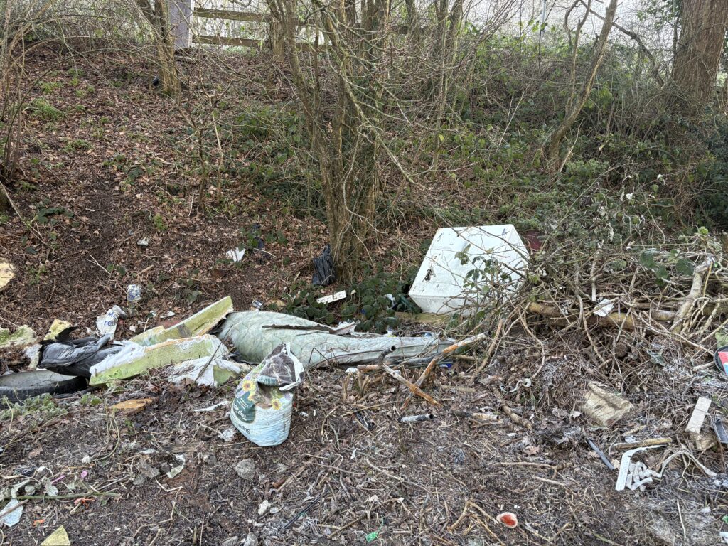 Fly-tipped rubbish in a roadside ditch near the A1081 in London Colney.
