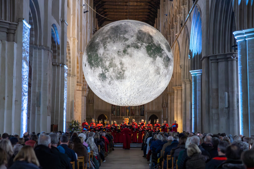 Cathedral choristers singing beneath the Moon. Photo: Toby Shepheard.