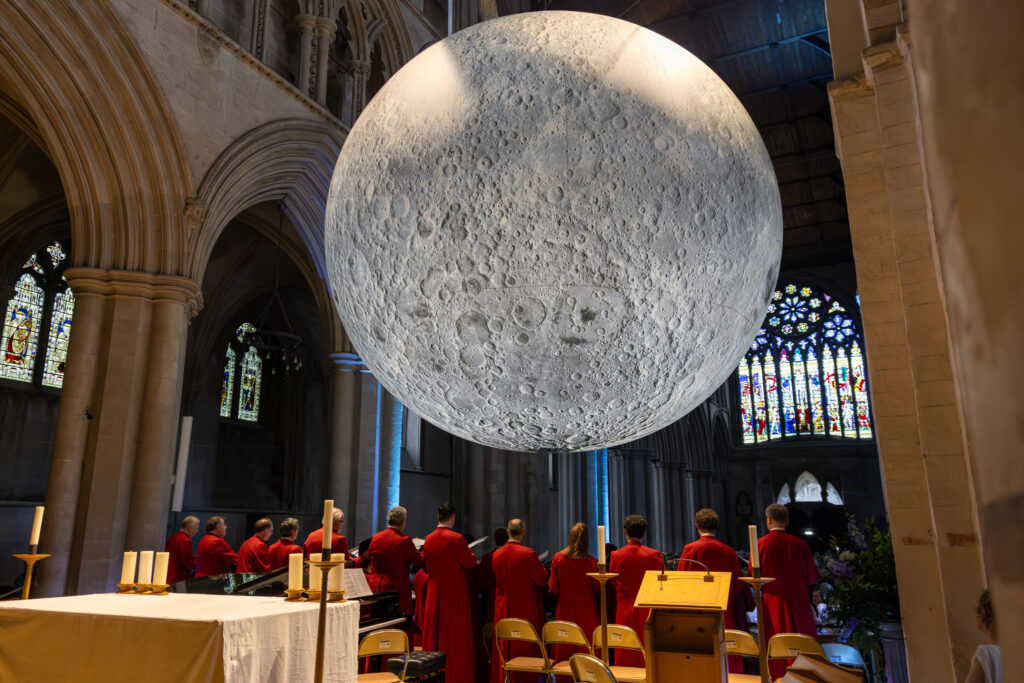 Cathedral choristers singing beneath the Moon. Photo: Toby Shepheard.