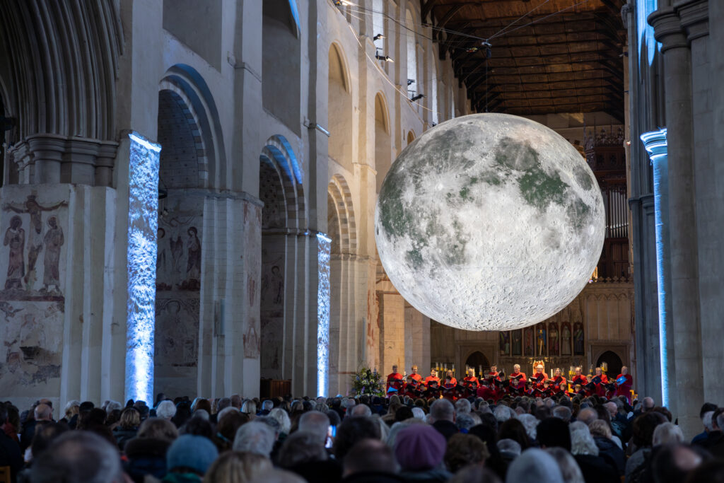 Cathedral choristers singing beneath the Moon. Photo: Toby Shepheard.
