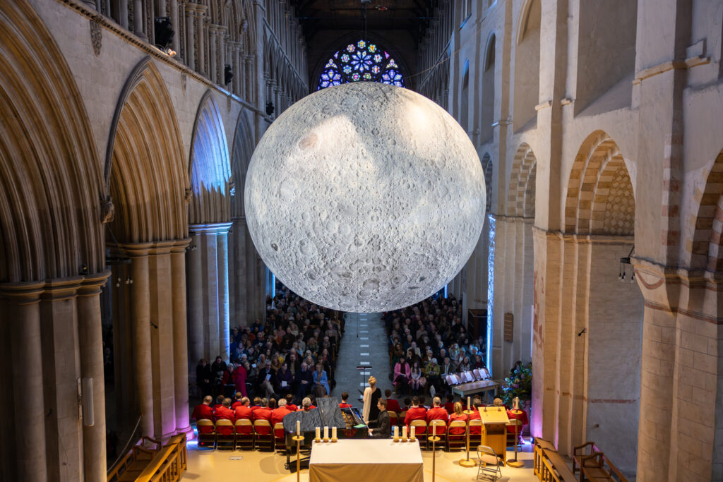 Cathedral choristers singing beneath the Moon. Photo: Toby Shepheard.