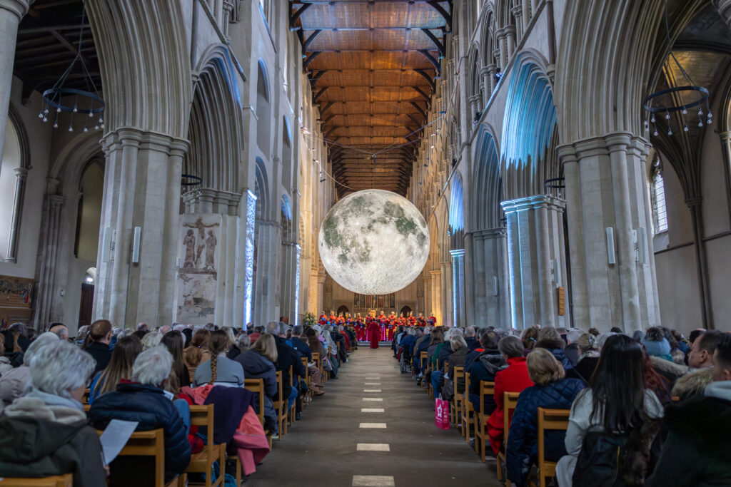 Cathedral choristers singing beneath the Moon. Photo: Toby Shepheard.