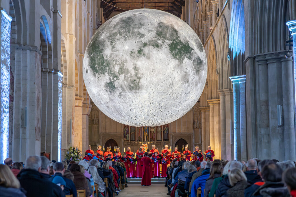 Cathedral choristers singing beneath the Moon. Photo: Toby Shepheard.