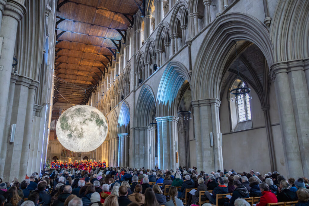 Cathedral choristers singing beneath the Moon. Photo: Toby Shepheard.
