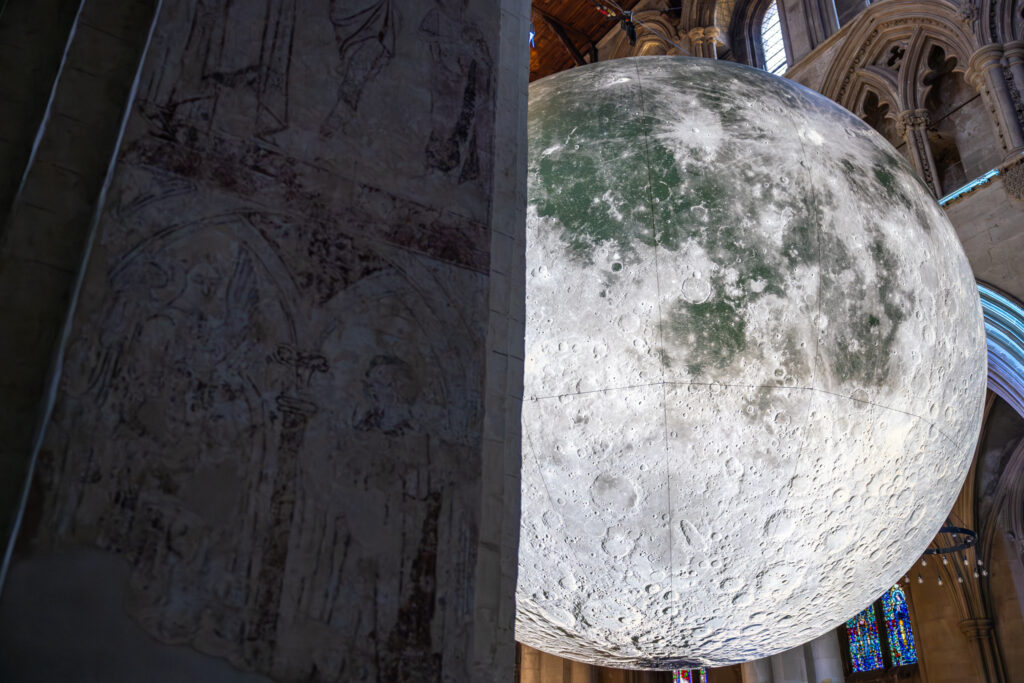 Cathedral choristers singing beneath the Moon. Photo: Toby Shepheard.