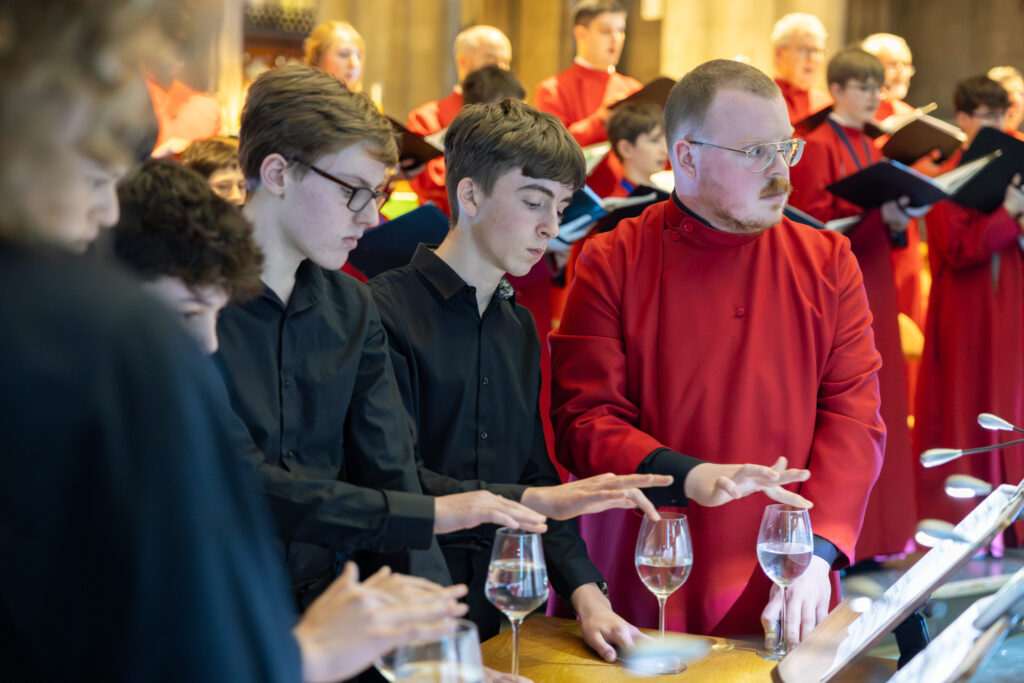 Cathedral choristers singing beneath the Moon. Photo: Toby Shepheard.