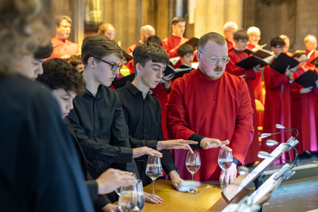 Cathedral choristers singing beneath the Moon. Photo: Toby Shepheard.