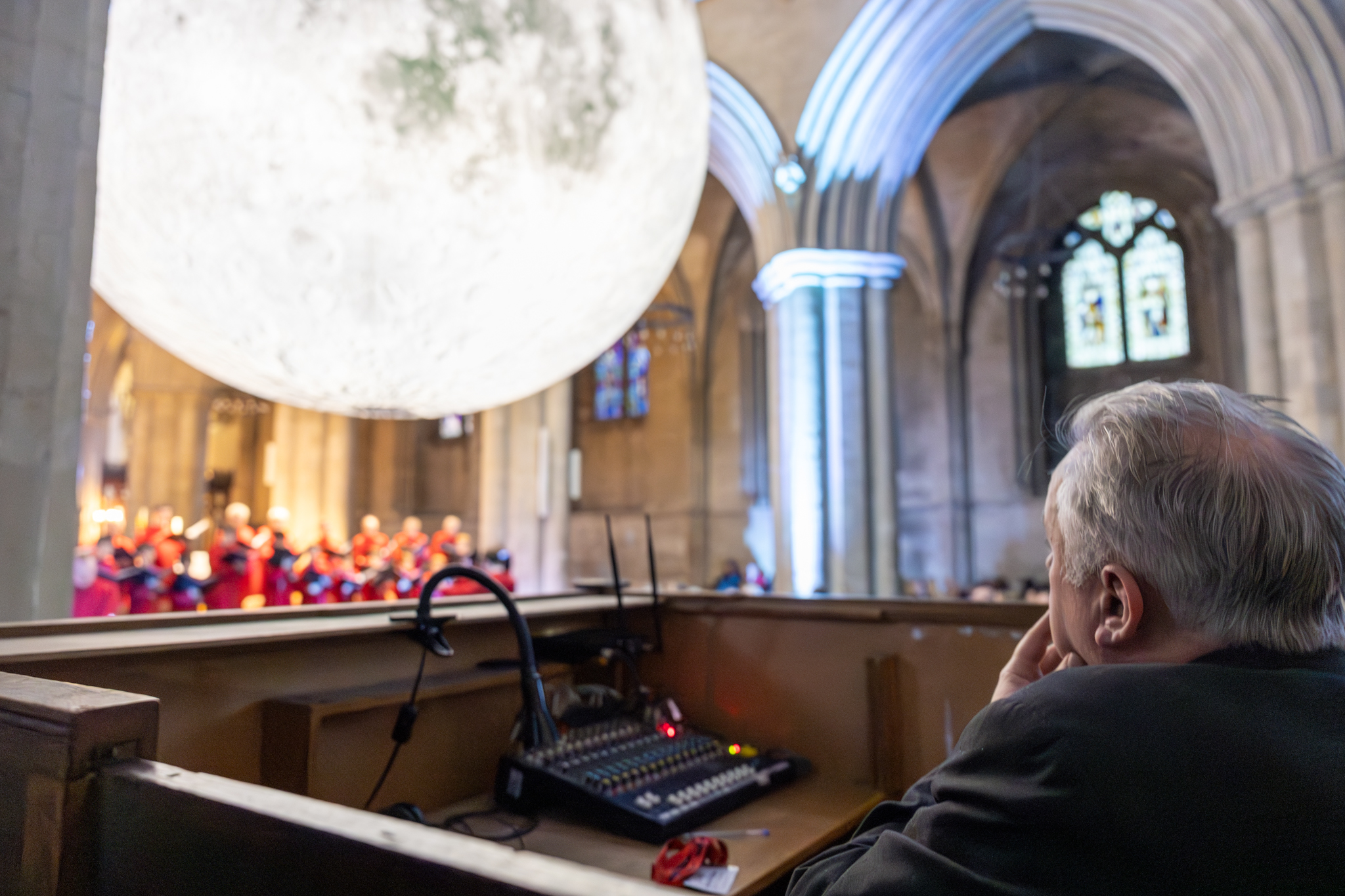 Cathedral choristers singing beneath the Moon. Photo: Toby Shepheard.