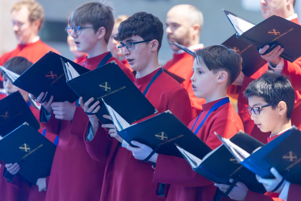 Cathedral choristers singing beneath the Moon. Photo: Toby Shepheard.