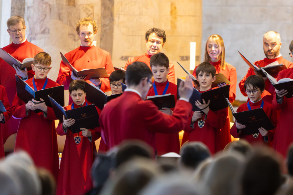 Cathedral choristers singing beneath the Moon. Photo: Toby Shepheard.