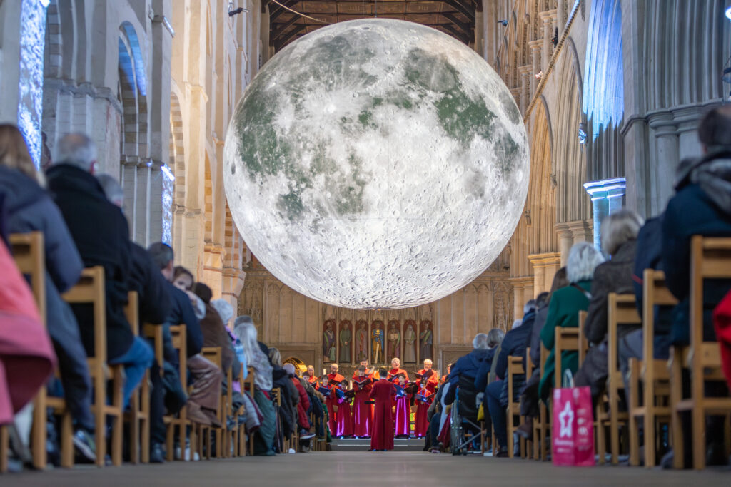 Cathedral choristers singing beneath the Moon. Photo: Toby Shepheard.