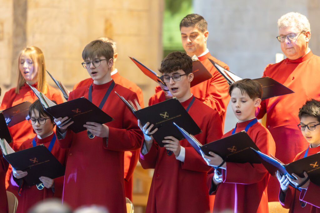 Cathedral choristers singing beneath the Moon. Photo: Toby Shepheard.