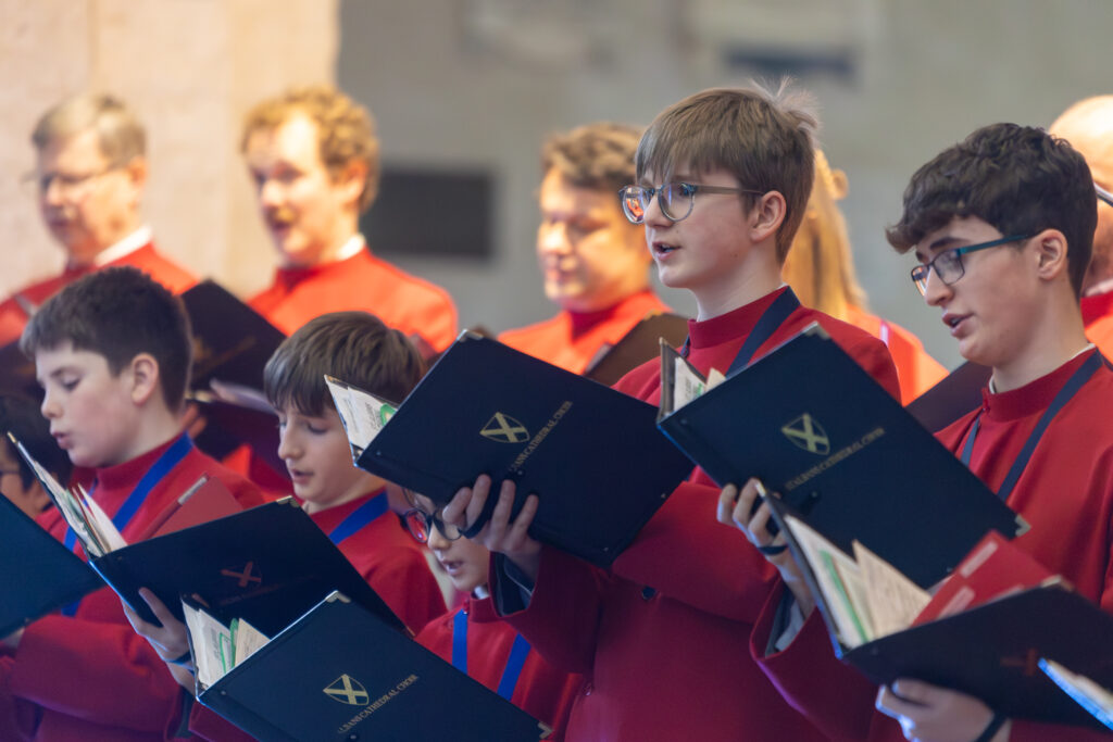 Cathedral choristers singing beneath the Moon. Photo: Toby Shepheard.