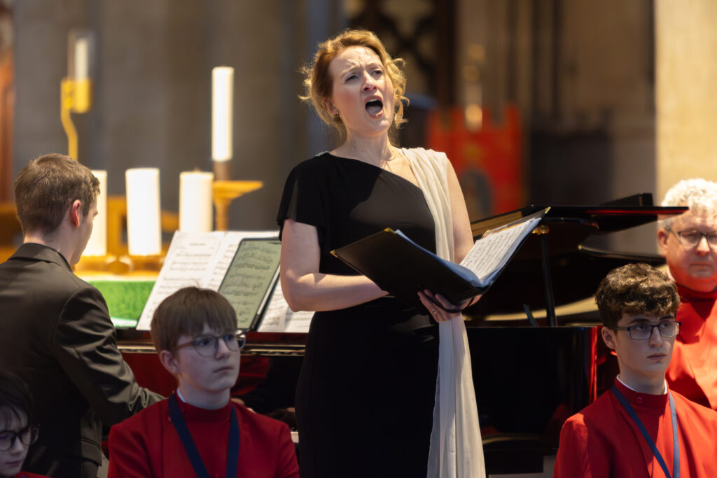 Cathedral choristers singing beneath the Moon. Photo: Toby Shepheard.