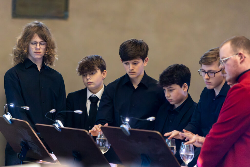 Cathedral choristers singing beneath the Moon. Photo: Toby Shepheard.