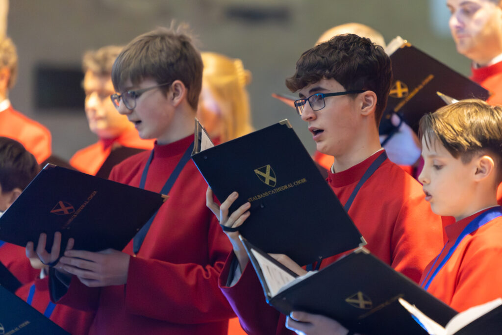 Cathedral choristers singing beneath the Moon. Photo: Toby Shepheard.