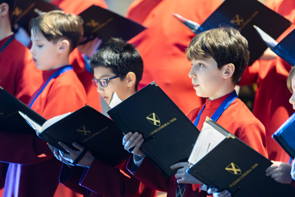 Cathedral choristers singing beneath the Moon. Photo: Toby Shepheard.
