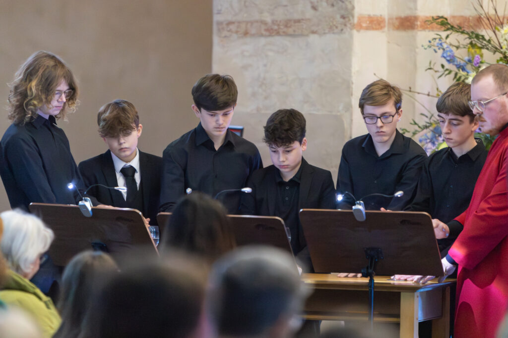 Cathedral choristers singing beneath the Moon. Photo: Toby Shepheard.
