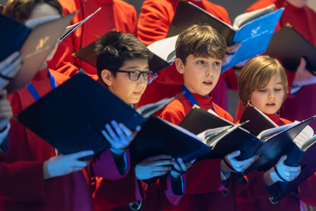 Cathedral choristers singing beneath the Moon. Photo: Toby Shepheard.