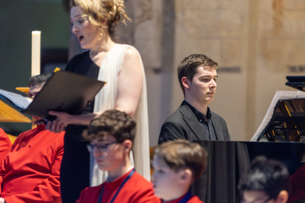 Cathedral choristers singing beneath the Moon. Photo: Toby Shepheard.