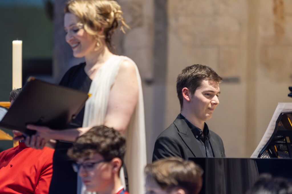Cathedral choristers singing beneath the Moon. Photo: Toby Shepheard.