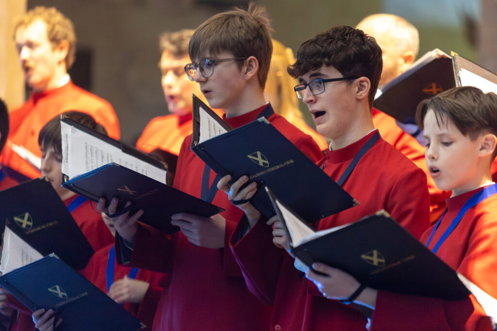 Cathedral choristers singing beneath the Moon. Photo: Toby Shepheard.