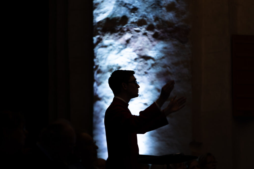 Cathedral choristers singing beneath the Moon. Photo: Toby Shepheard.
