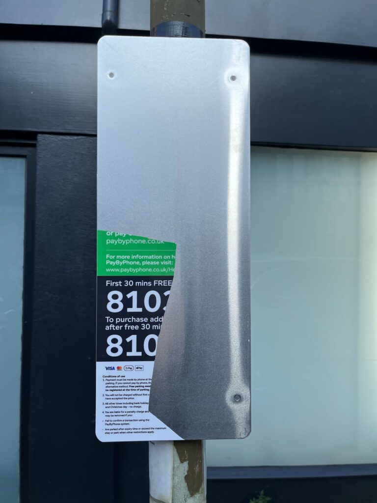 A vandalised parking sign