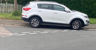 A car mounting the pavement in New Greens.