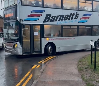 A bus mounting the pavement in New Greens.