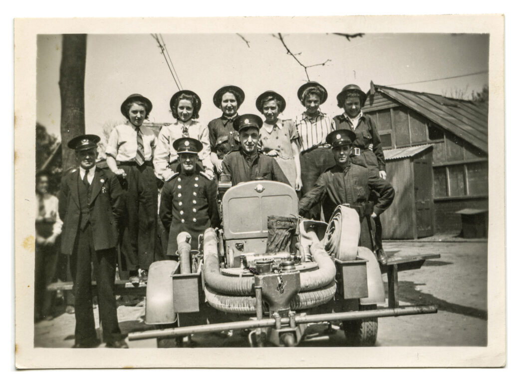Volunteers for the Auxiliary Fire Service (who supported the Fire Brigade) posing in front of their pump - despite what the photo suggests the women were not allowed to operate the pump but staffed the telephone line.