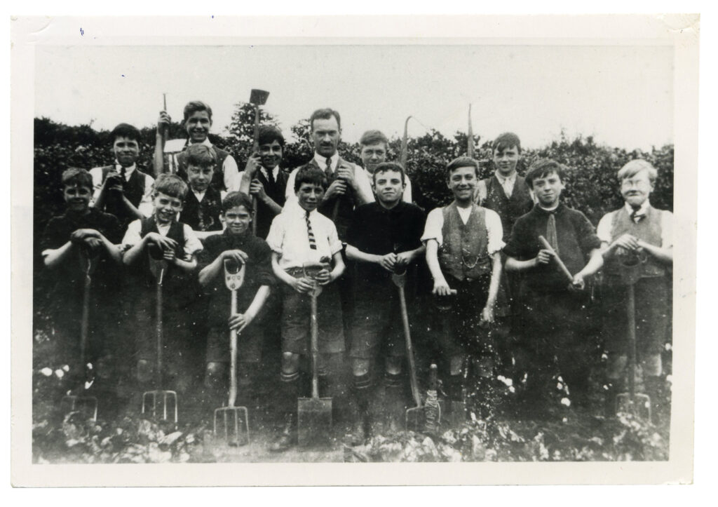 Mr. Houseden, the head teacher at St. Helen's school posing with his gardening club on the school allotment - according to later accounts by the boys Mr Houseden was a lot more enthusiastic about gardening than his pupils who regarded him as a slave-driver.